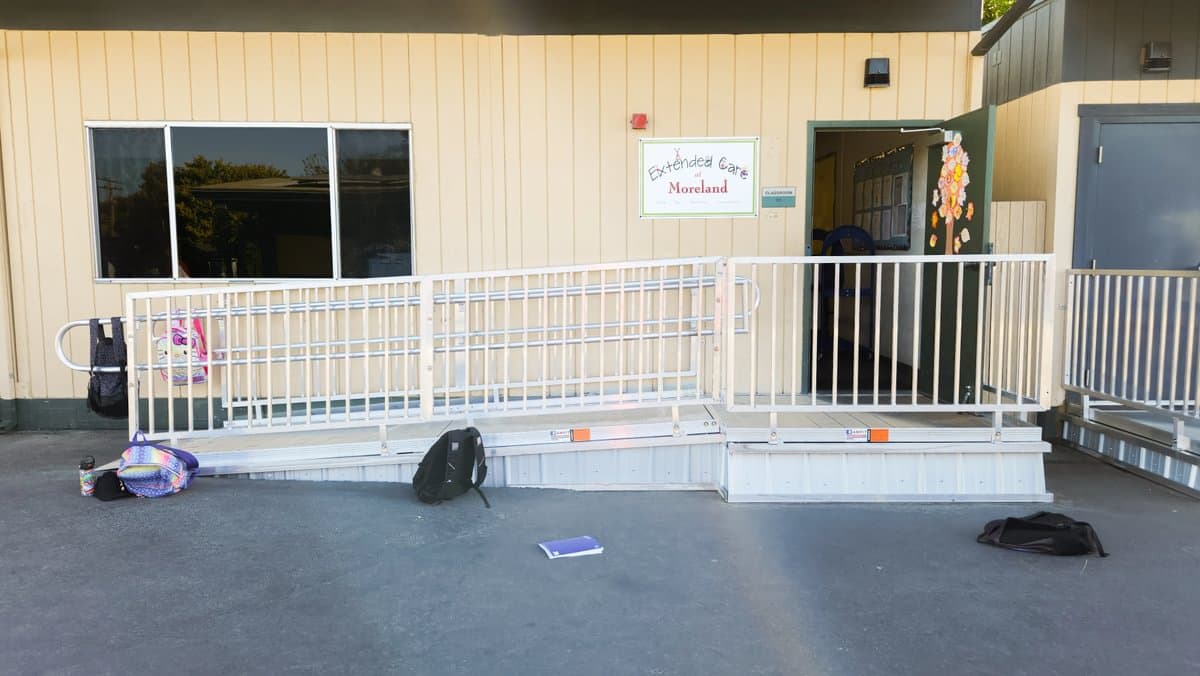 Wide aluminum access ramp installed at a commercial building entry