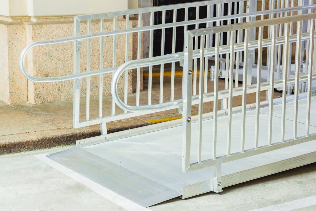 Aluminum wheelchair ramp with platform installed at a residential home front entry