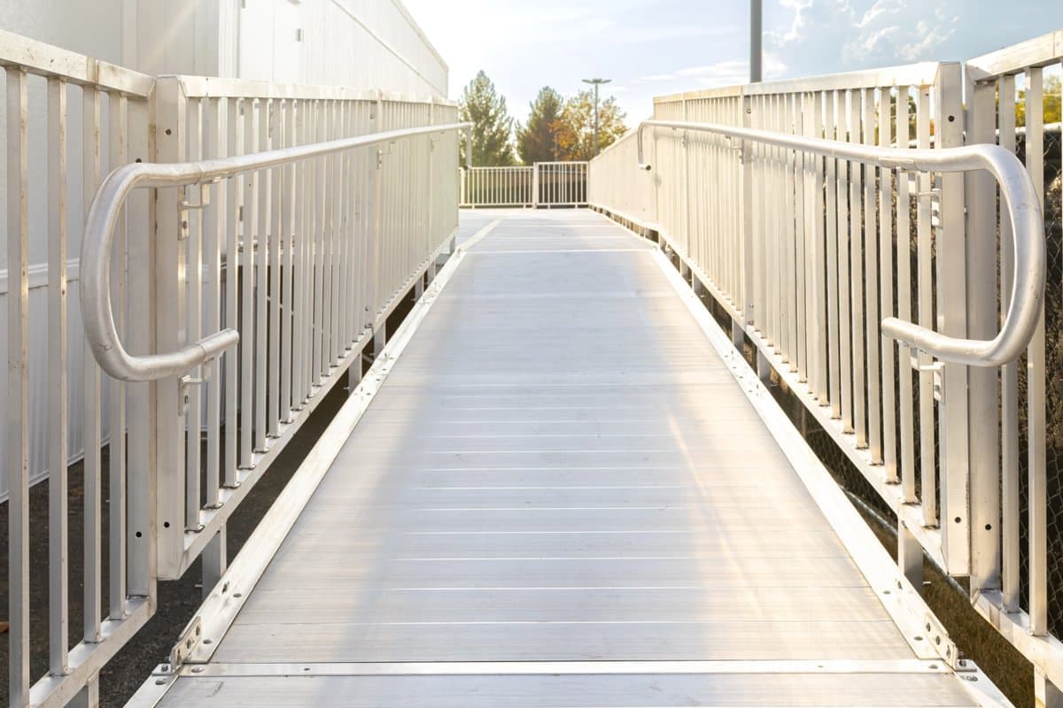 Custom aluminum ramp with landing platform at a residential home