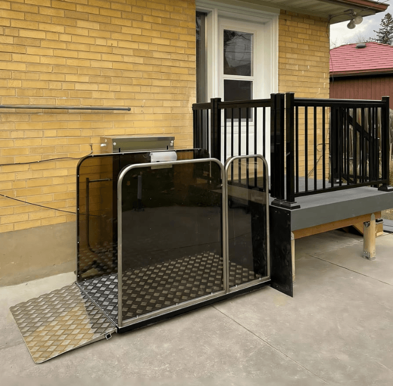 Serenity Standard wheelchair lift installed alongside a raised backyard deck